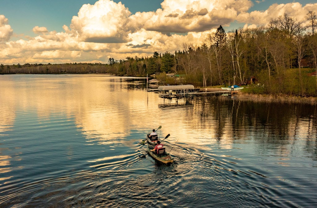 Two people kayak on the lake