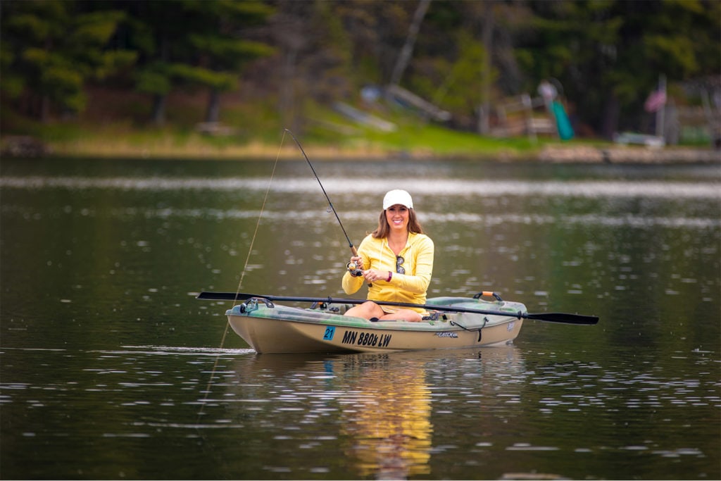 woman fishing on kayak