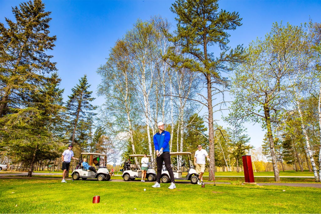 A man teeing off at a golf course