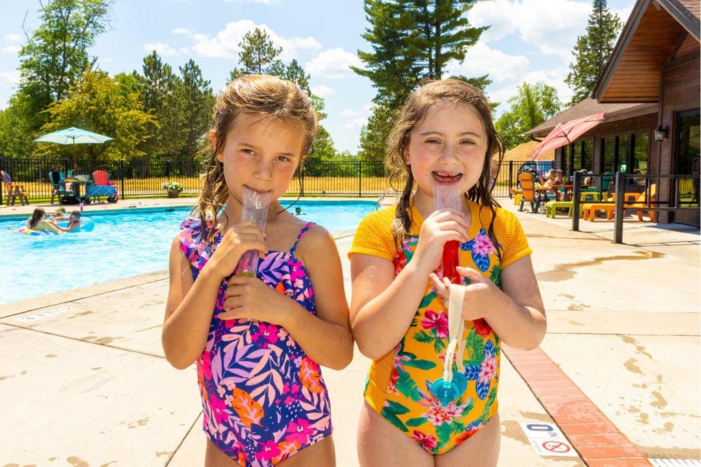 Two kids enjoying popsicles